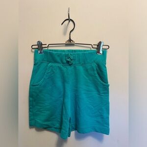 Circo, girls youth medium, teal shorts with a bow on front.